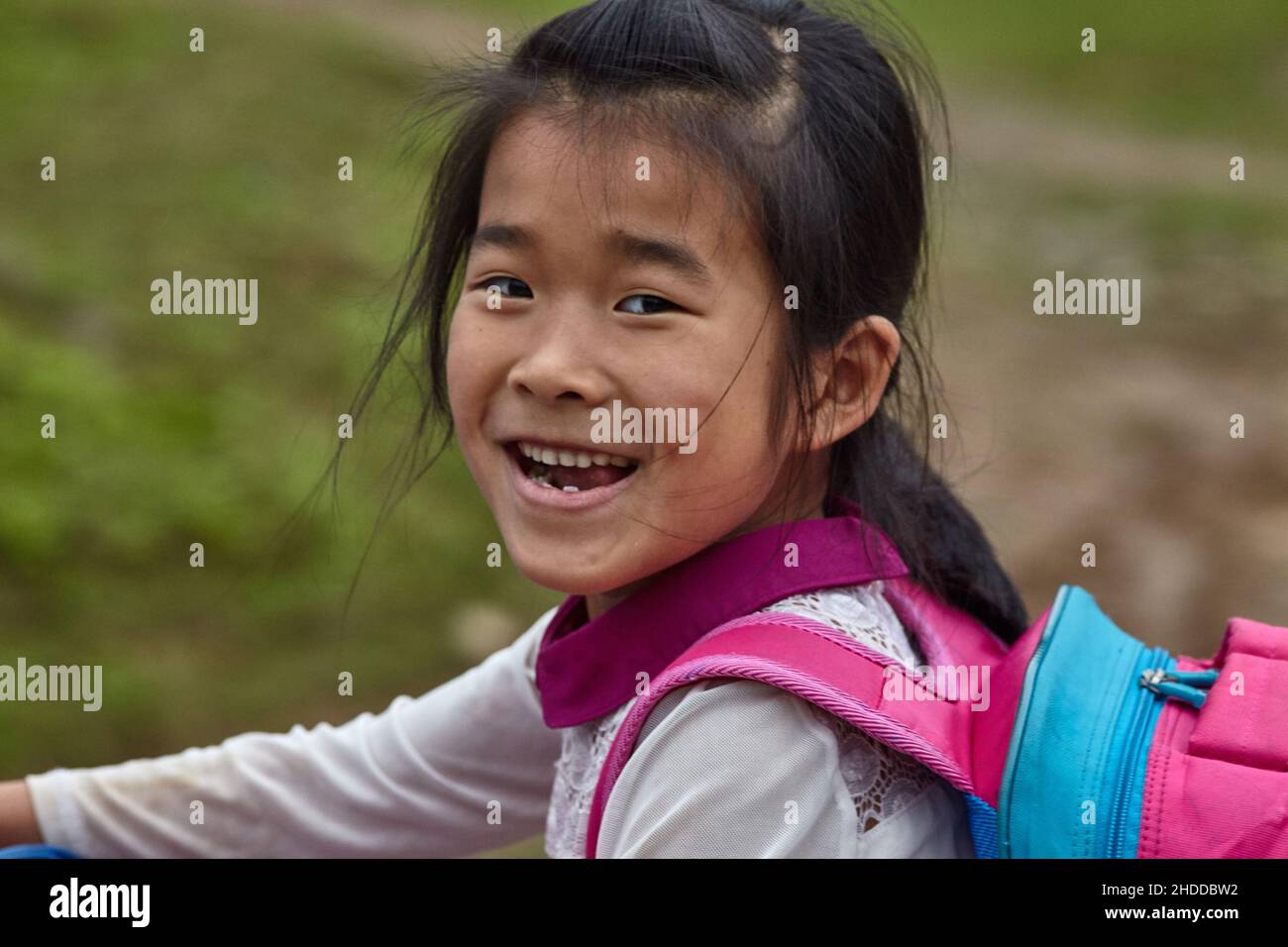 Vietnamese young  girl with beaming smile looks at camera Stock Photo