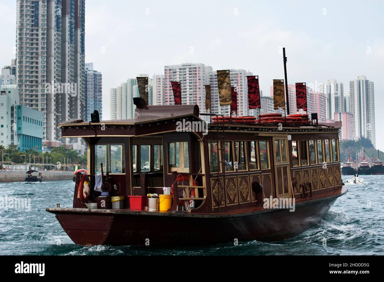 A sampan in Aberdeen Harbour with tower blocks beyond, Hong Kong, 2013 Stock Photo