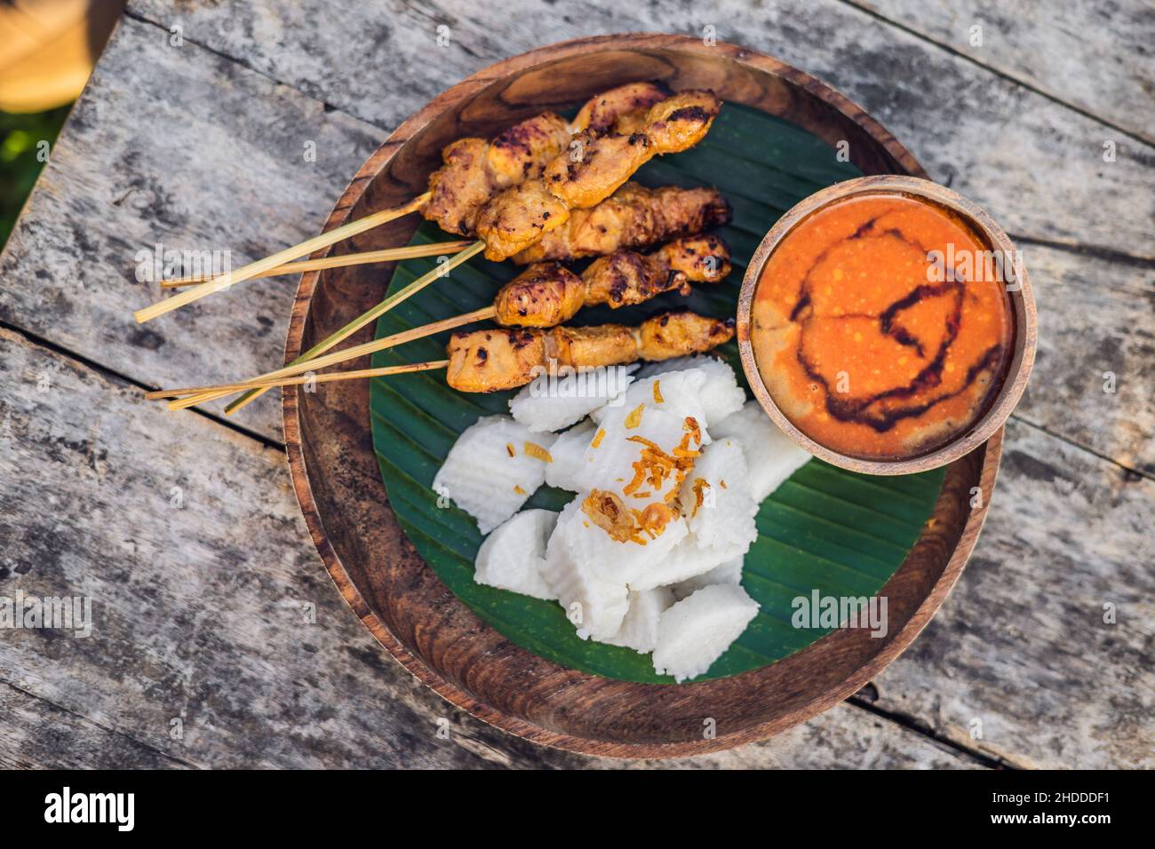 Indonesian chicken satay or Sate Ayam served with lontong, soy sauce