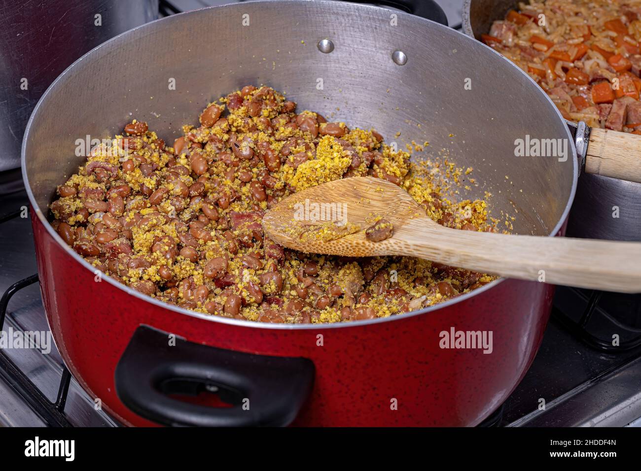 Tropeiro beans with manioc flour and pepperoni sausage in the pan Stock Photo