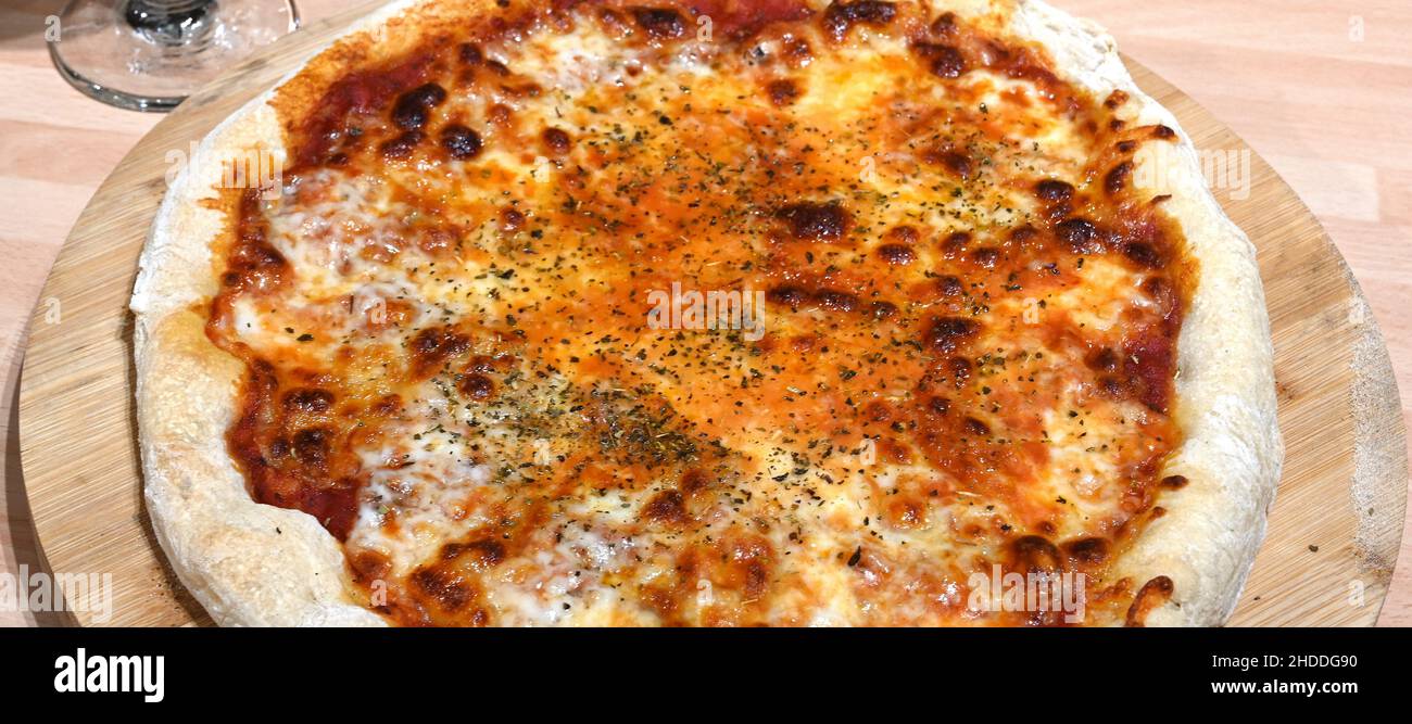 Italian cuisine, Pizza fresh from the pizza oven, Mediterranean cuisine Stock Photo