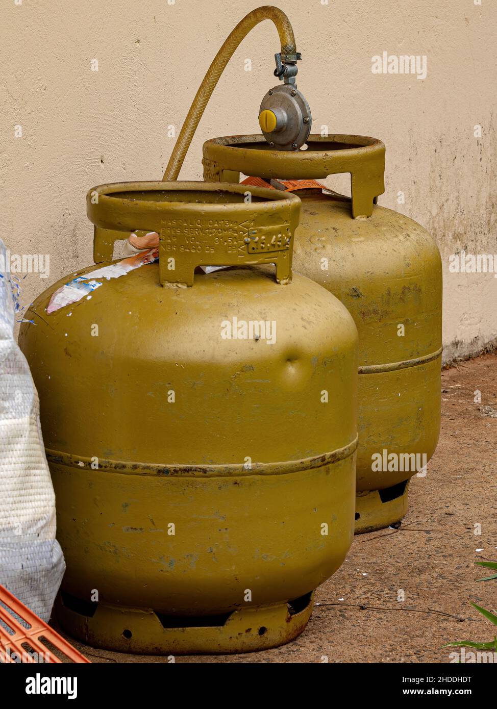 Two golden cooking gas cylinders outside the house Stock Photo Alamy
