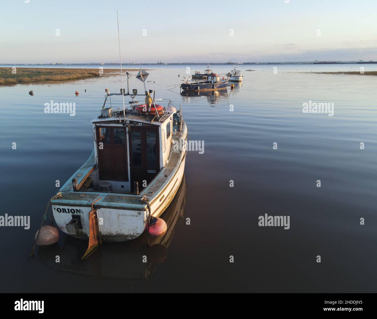 Small shipping boats moored in tranquil harbour Stock Photo