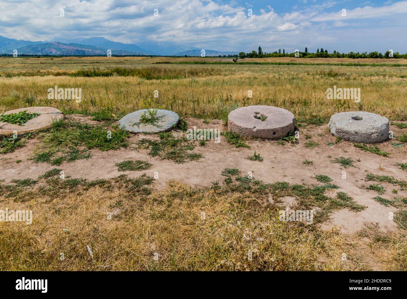 Ancient millstones near the Burana tower, Kyrgyzstan Stock Photo