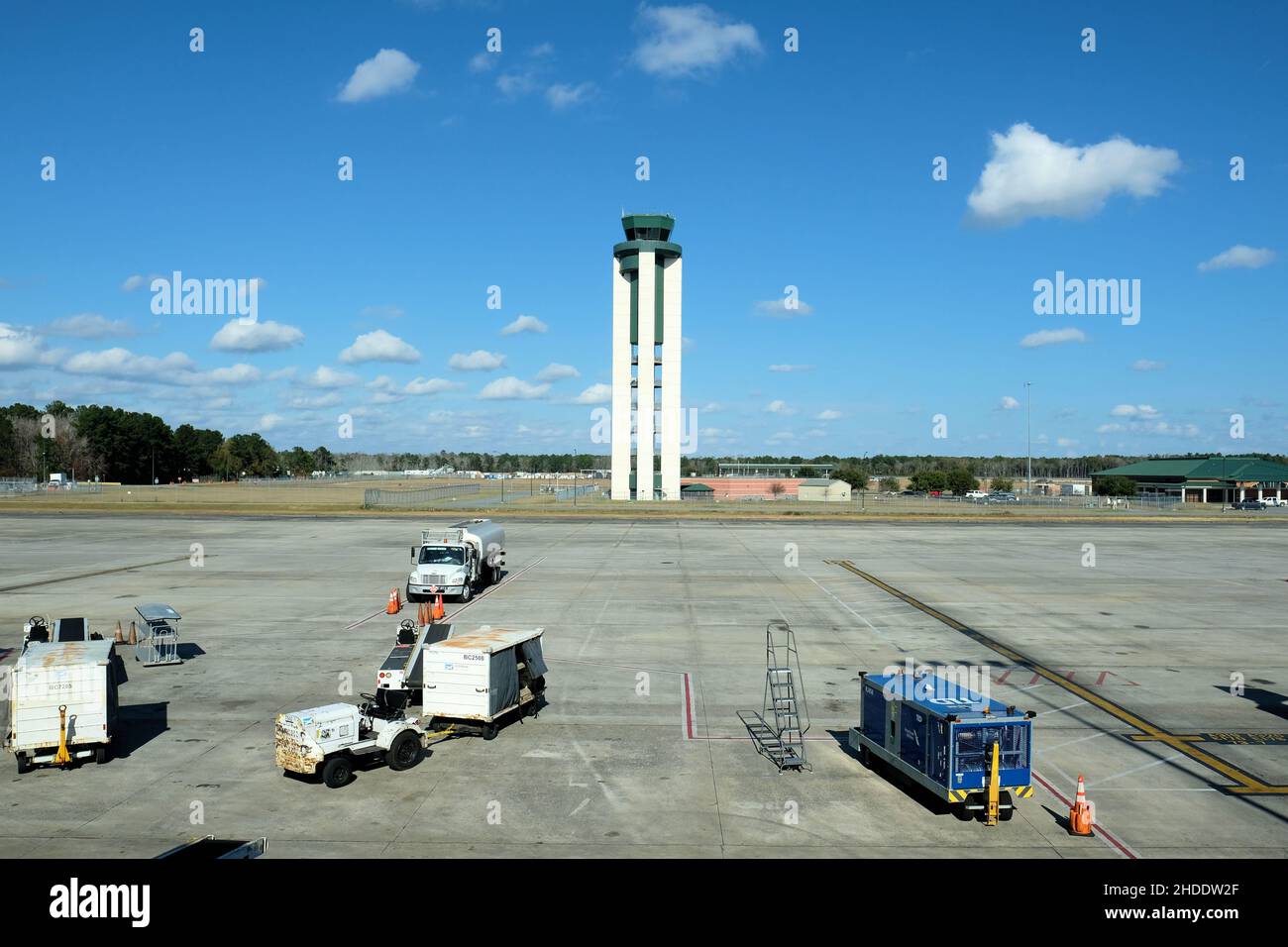 Air traffic control tower with service vehicles on jetway and tarmac at Savannah-Hilton Head Airport in Savannah, Georgia, USA. Stock Photo