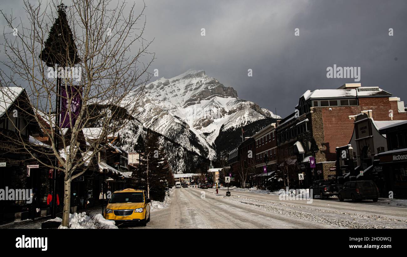 Banff, Canada - Dec. 22 2021: Downtown Banff winter Christmas view with background of rockie mountains Stock Photo