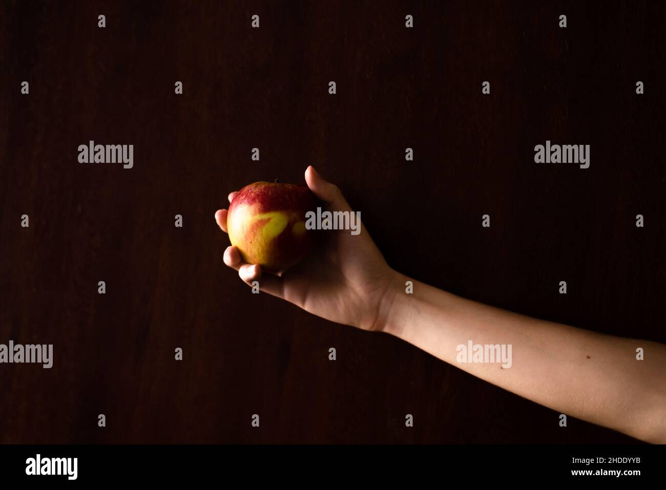 Hand holding red apple dark hi-res stock photography and images - Alamy