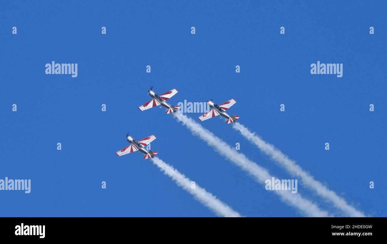 Thiene Italy OCTOBER, 16, 2021 Group of airplanes in the blue sky with smoke and huge copy space. Yakovlev Yak-52 by YAK Italia Stock Photo