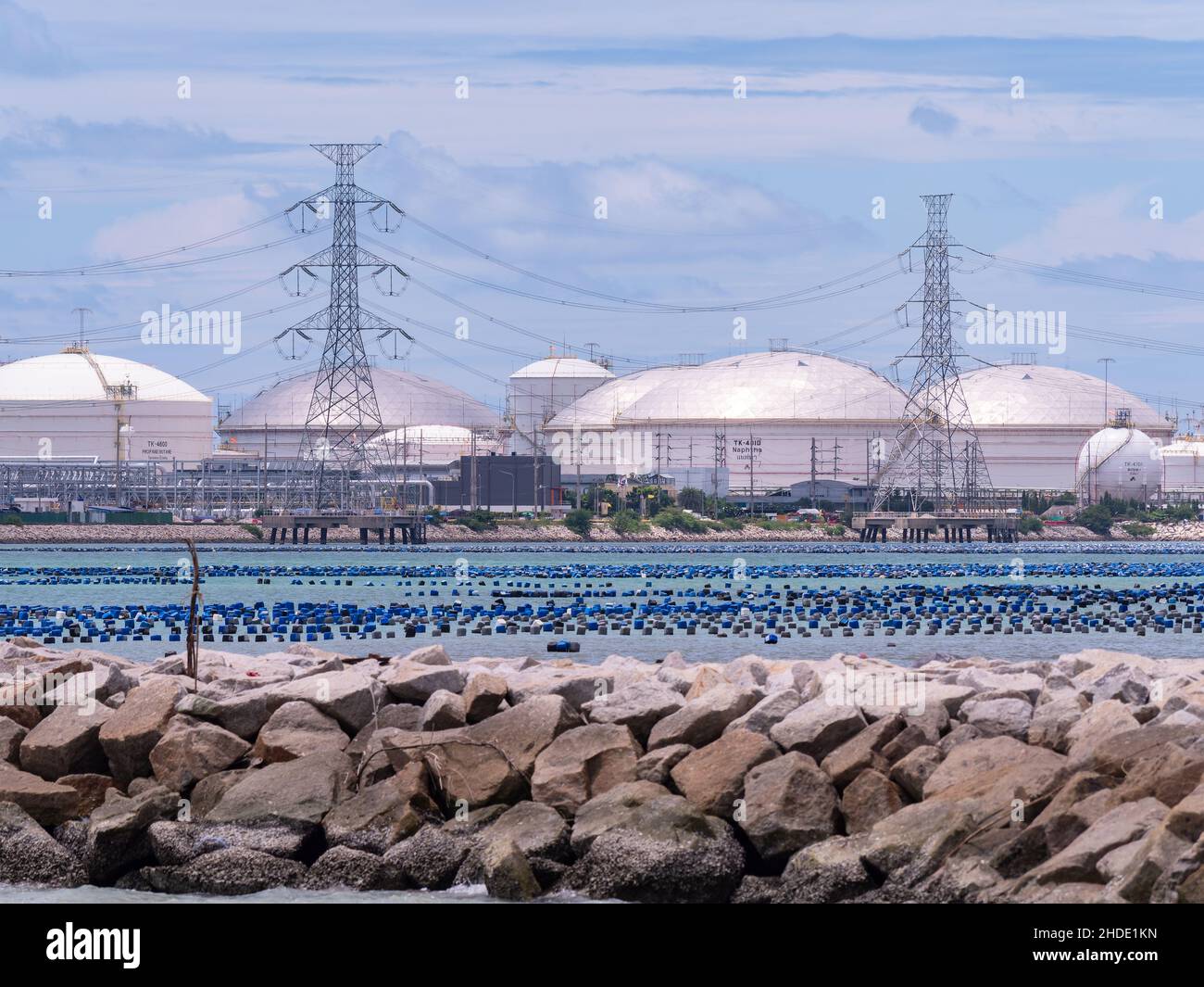 Storage tanks for petroleum products at Map Ta Put in the Rayong Province of Thailand. Oyster and mussel farms in the foreground. Stock Photo