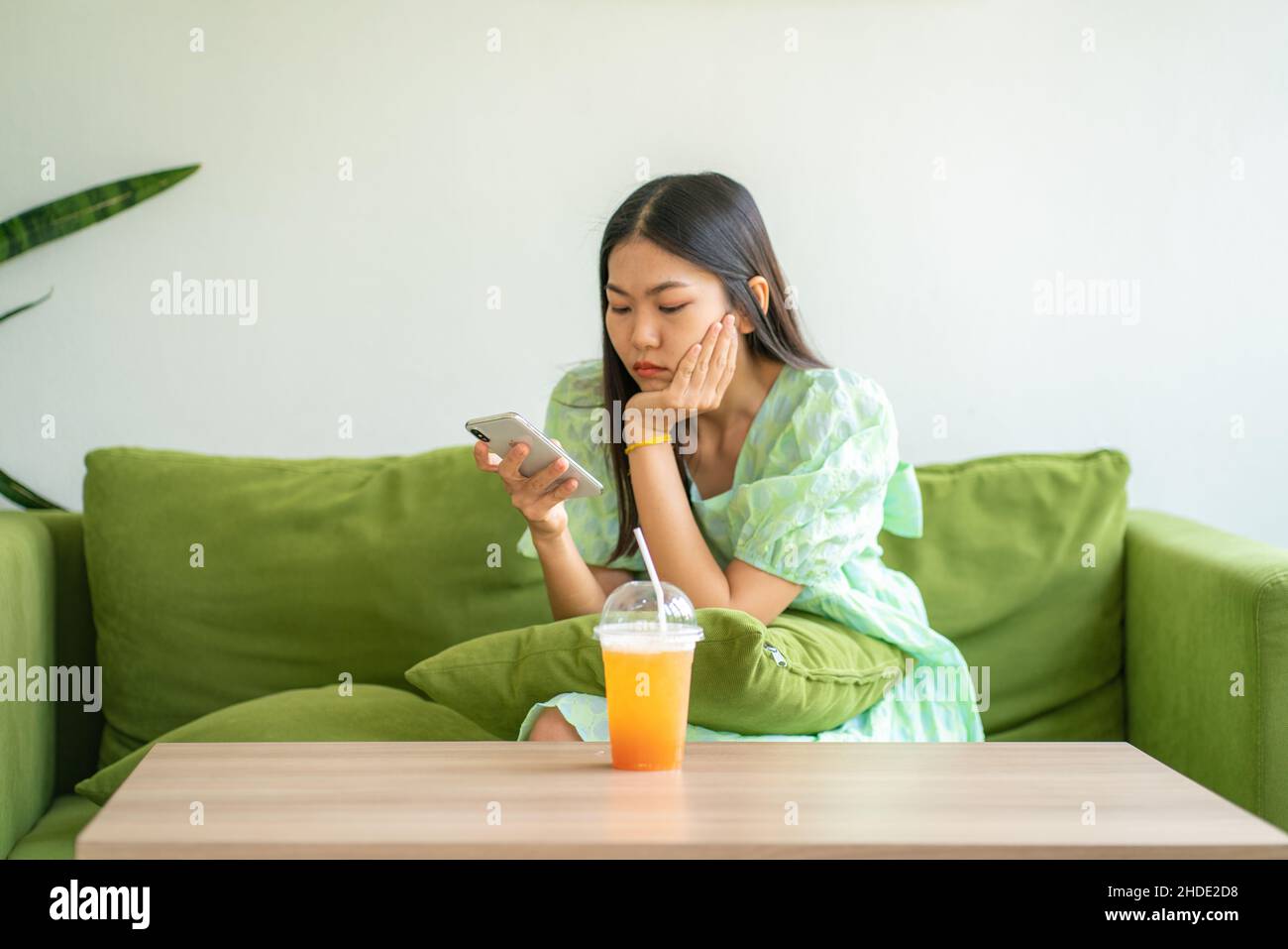 Beautiful asian women sitting in cafe use smartphone social media with ...