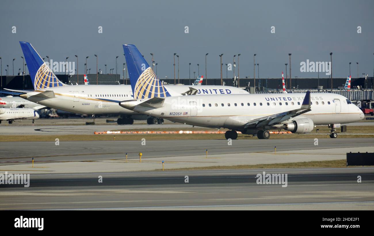 United Airlines Boeing 787 Dreamliner and United Express Embraer 175 taxi on the runway at Chicago O'Hare International Airport. Stock Photo