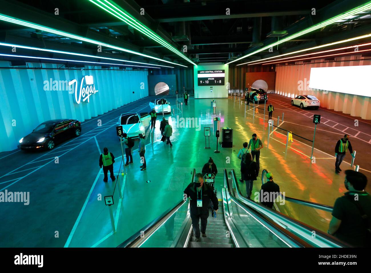 Attendees ride in Tesla electric vehicles through underground tunnels to get to exhibit halls