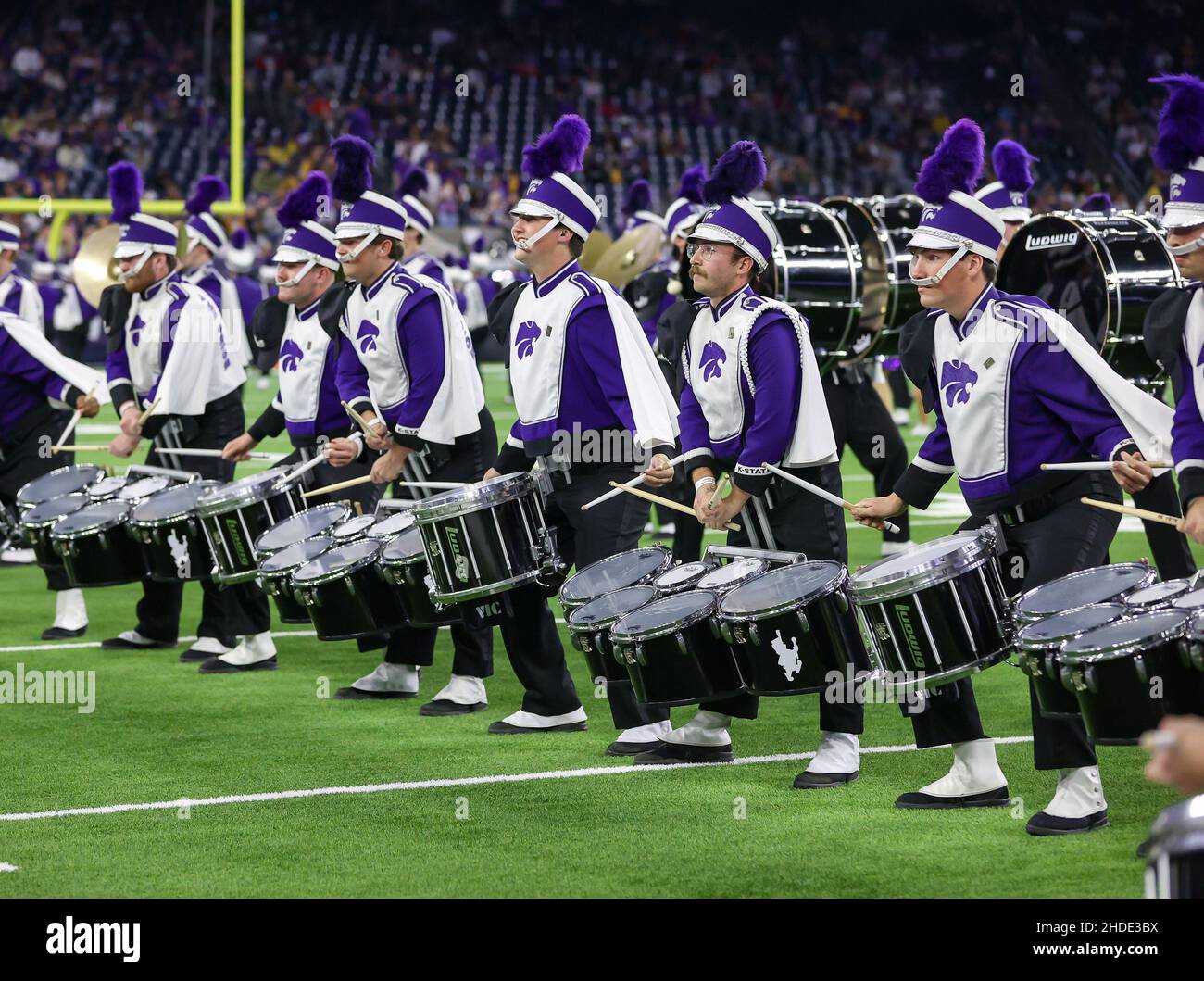 Houston, TX, USA. 4th Jan, 2022. The Kansas State marching band drumline does a sectional solo during the halftime show of the 2022 TaxAct Texas Bowl football game between the LSU Tigers and the Kansas State Wildcats at NRG Stadium in Houston, TX. Kyle Okita/CSM/Alamy Live News Stock Photo