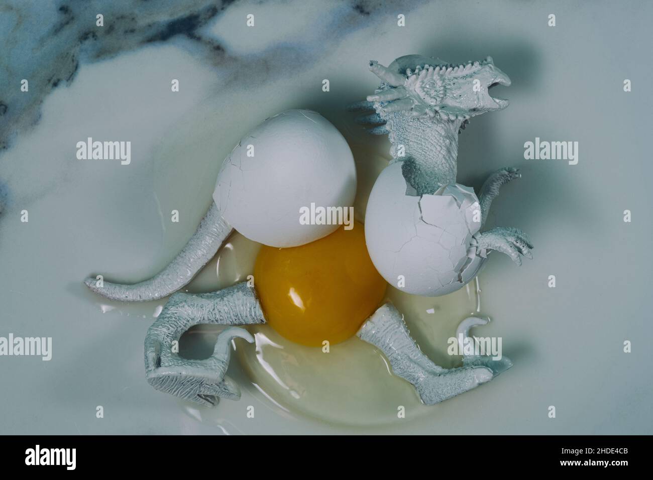 Creepy abstract hatched dead dinosaur egg with yoke concept Stock Photo