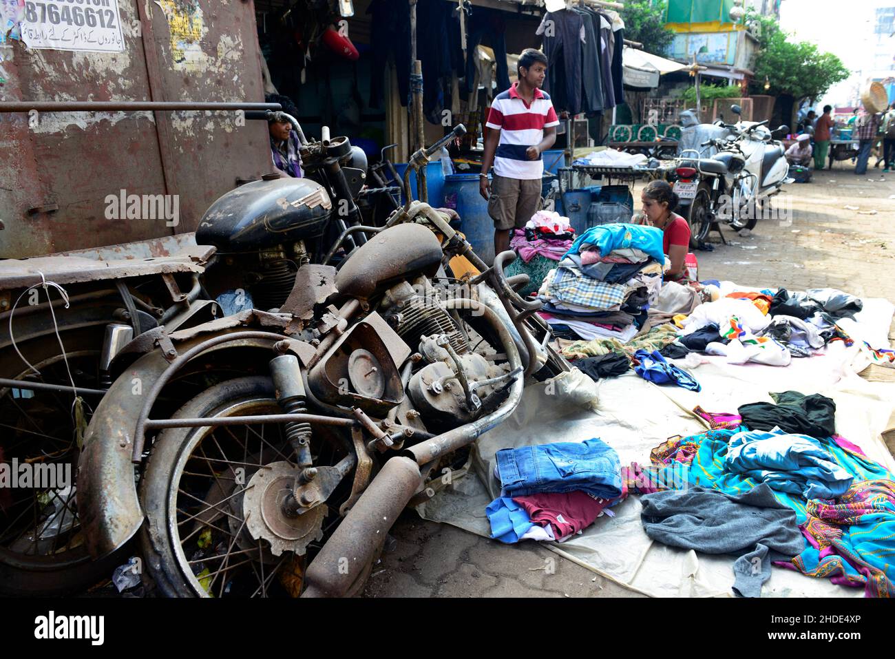 An old motorbike in a busy market near Dhobi ghat in Mumbai, India. Stock Photo