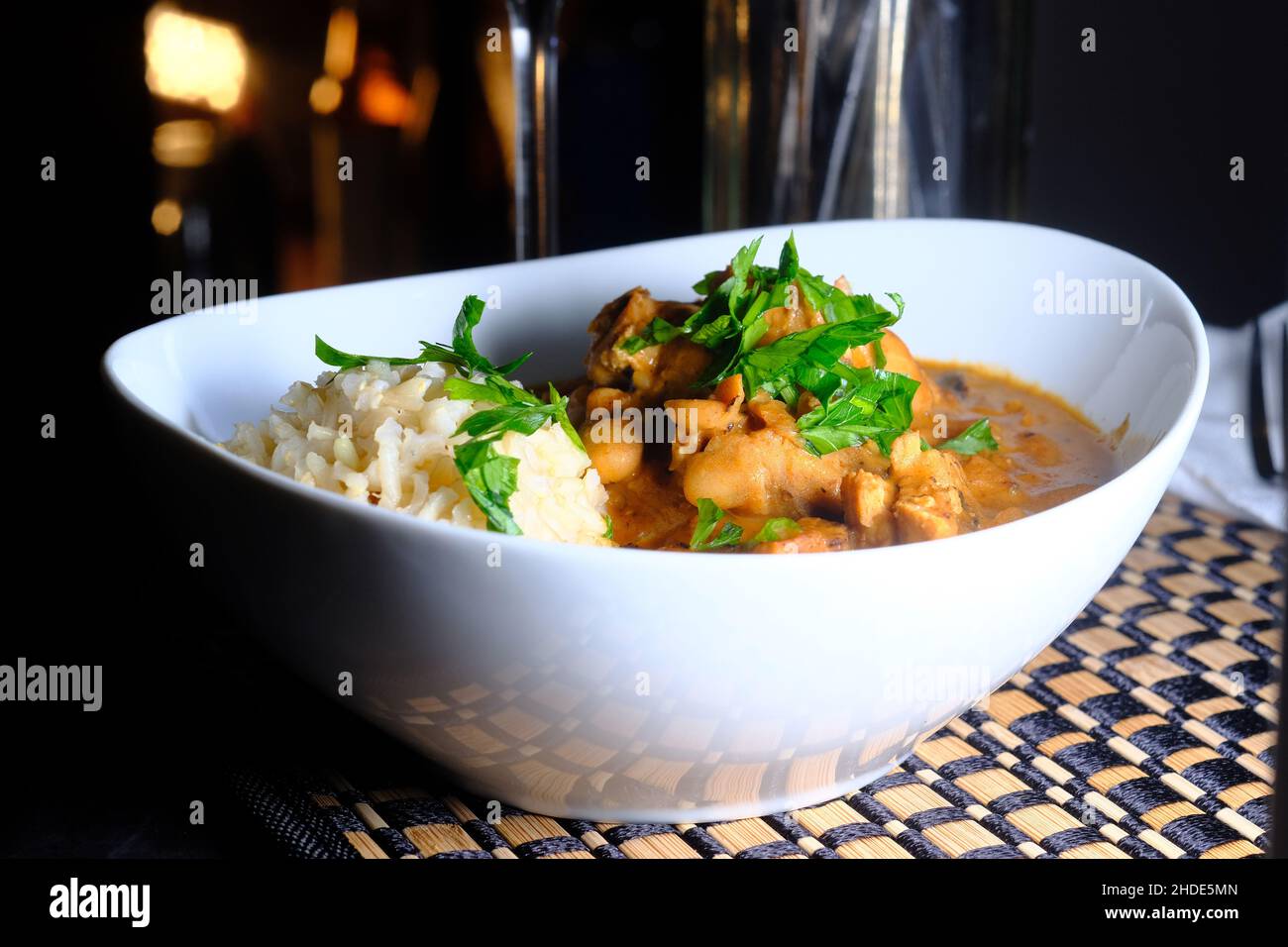 Hungarian chicken paprikash with brown rice and parsley garnish Stock Photo