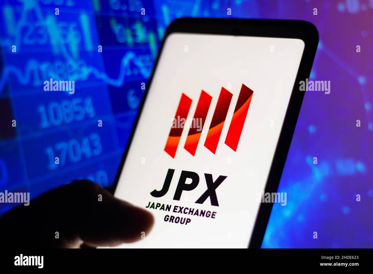 Brazil. 05th Jan, 2022. In this photo illustration, Japan Exchange Group (JPX) logo seen displayed on a smartphone with a stock market chart in the background. Credit: SOPA Images Limited/Alamy Live News Stock Photo