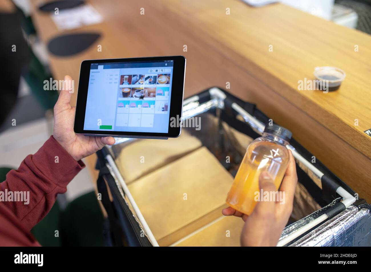 Courrier checking the order for food delivery Stock Photo Alamy