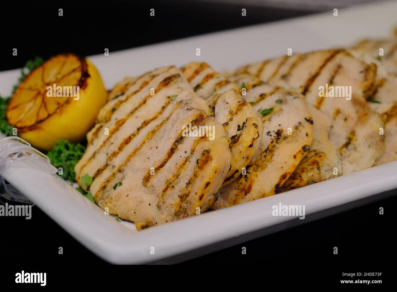 Barbecue chicken with grill marks on retail display at local market Stock Photo