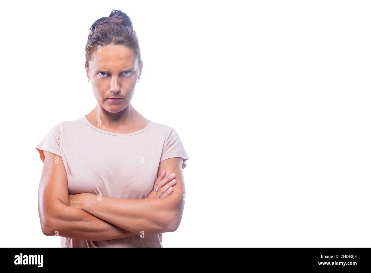 self-assured woman with her arms crossed looking at camera Stock Photo