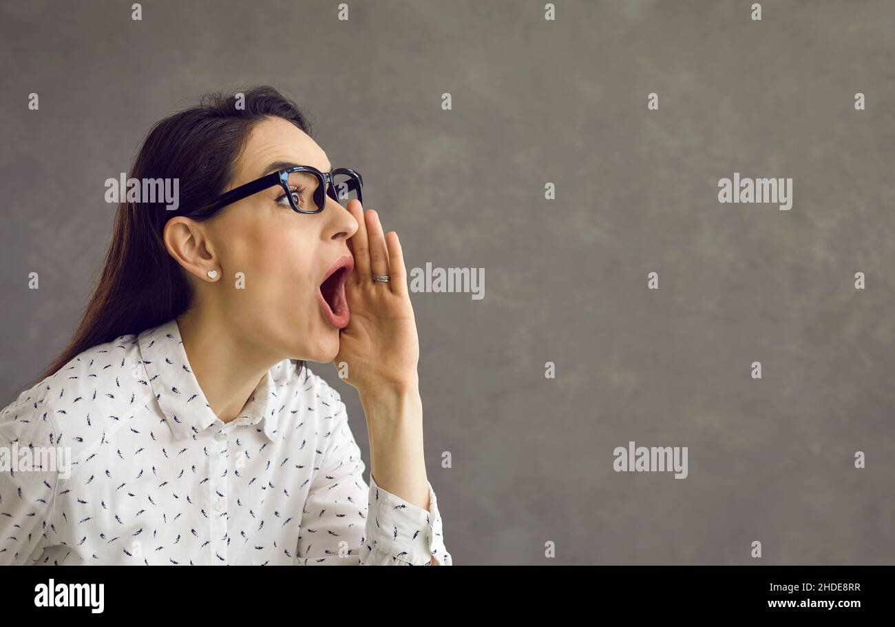 Woman who loudly announces advertisements, news and information about discounts. Stock Photo