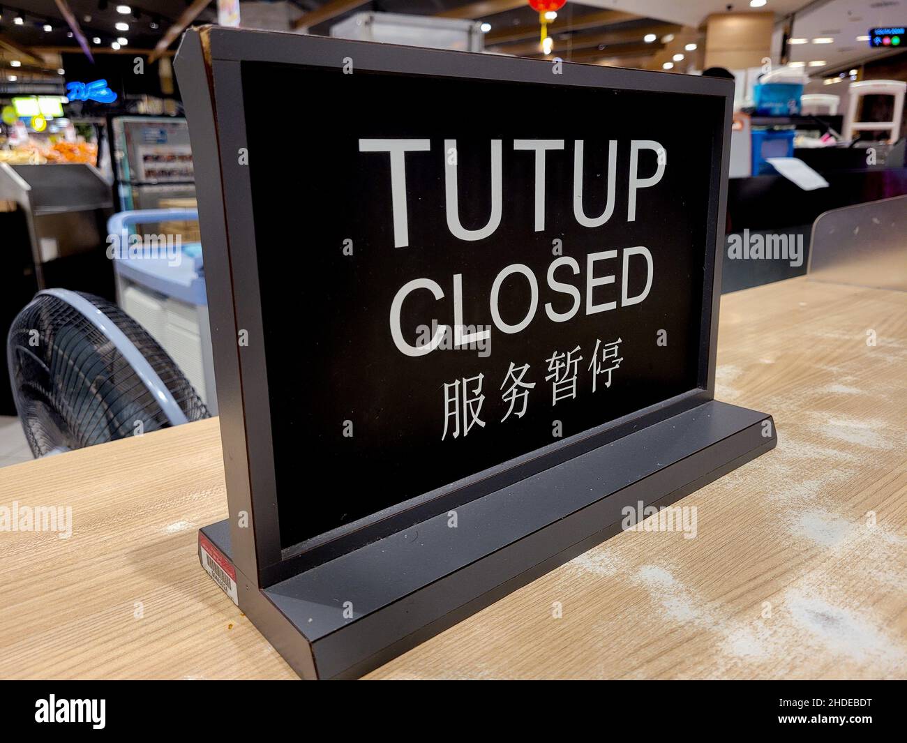 Closed sign on the counter. Stock Photo