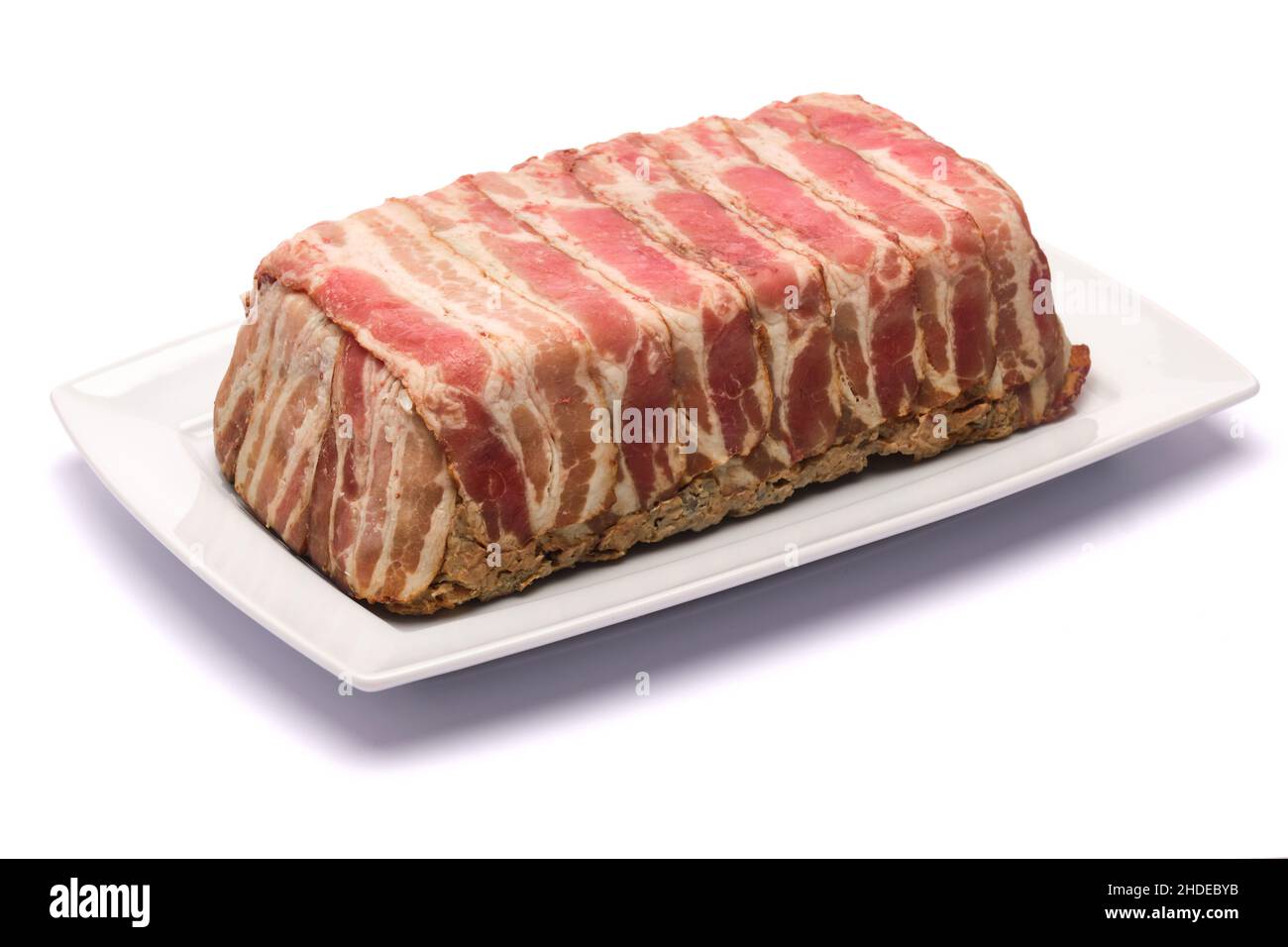 Traditional French terrine covered with bacon isolated on white