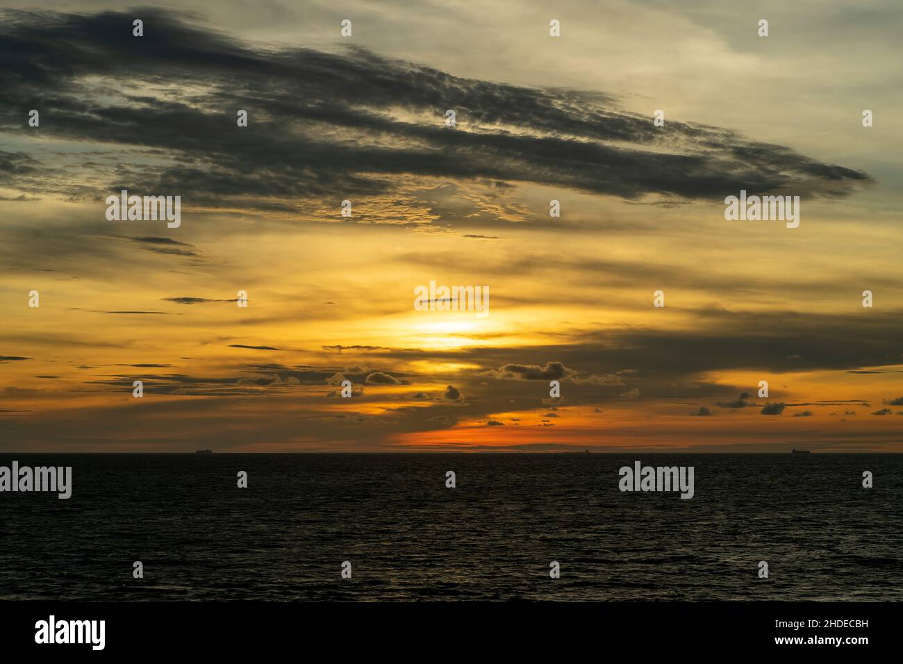Dramatic clouds and sunset sky over the sea with golden clouds in Port ...