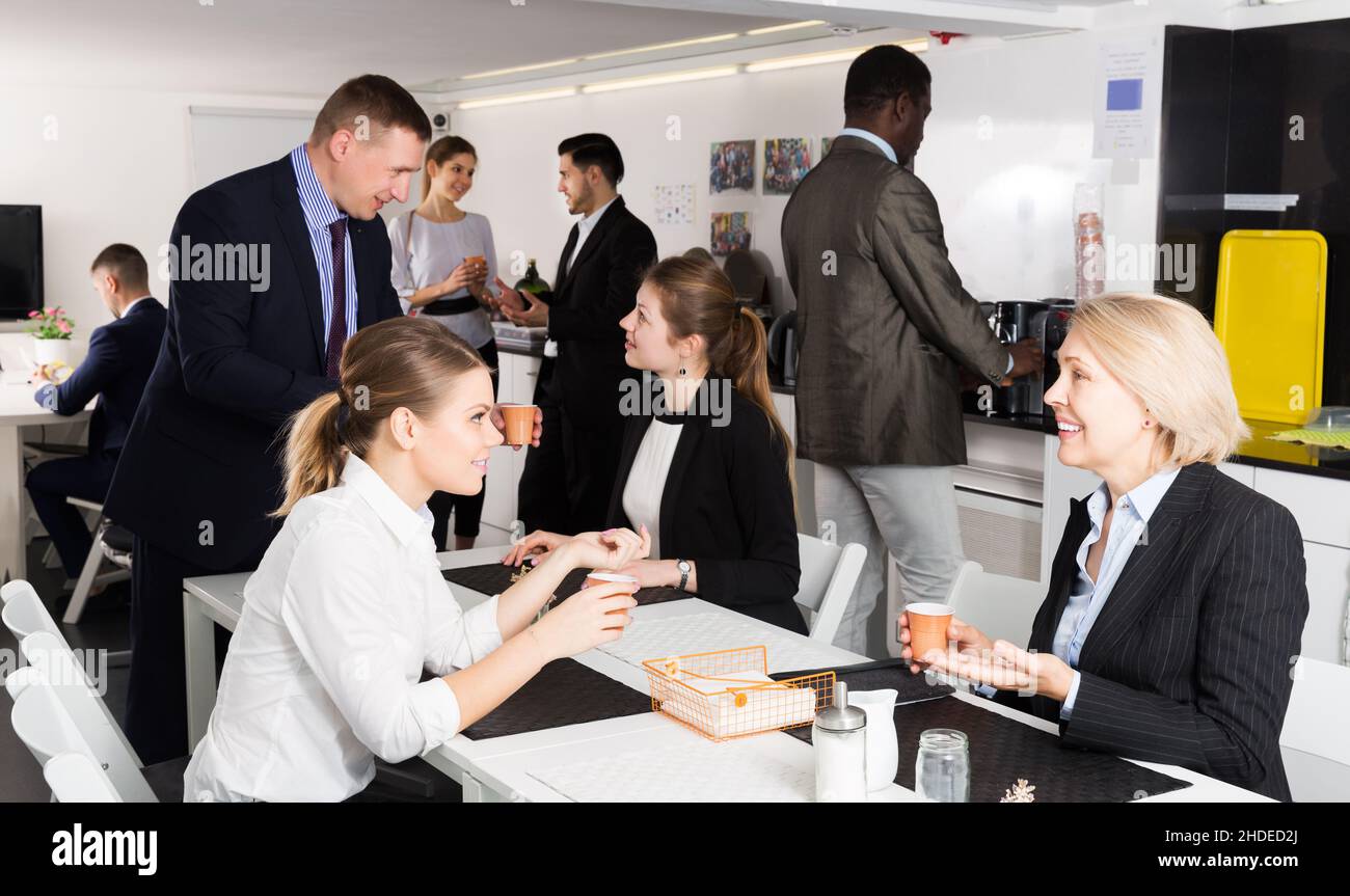 business people chatting while enjoying coffee Stock Photo
