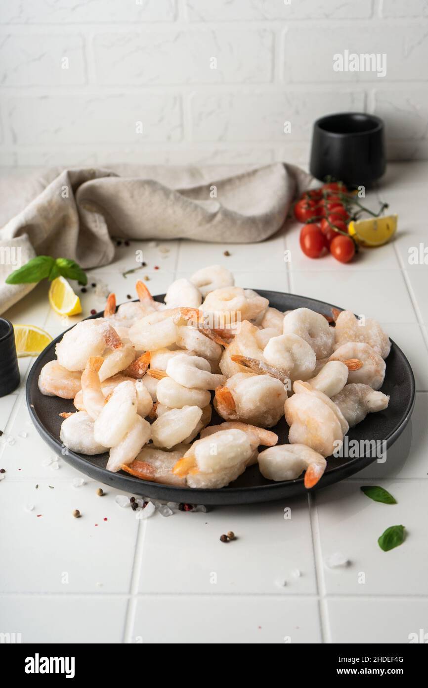 Thawed peeled shrimp, seafood, delicacy. on a white background, in a ...