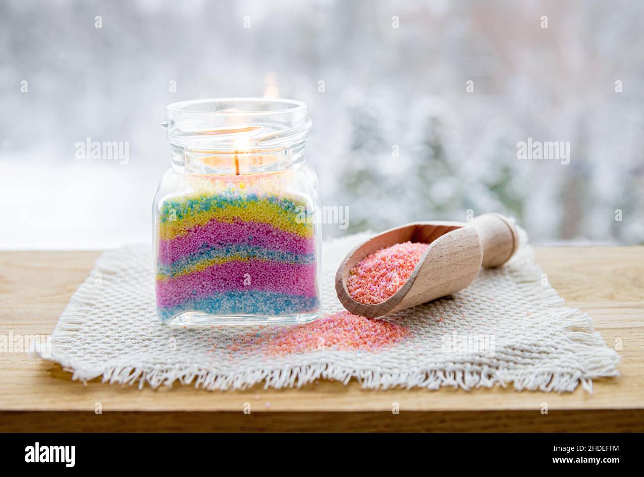 Child made fun colorful layered wax powder candle in home by pouring