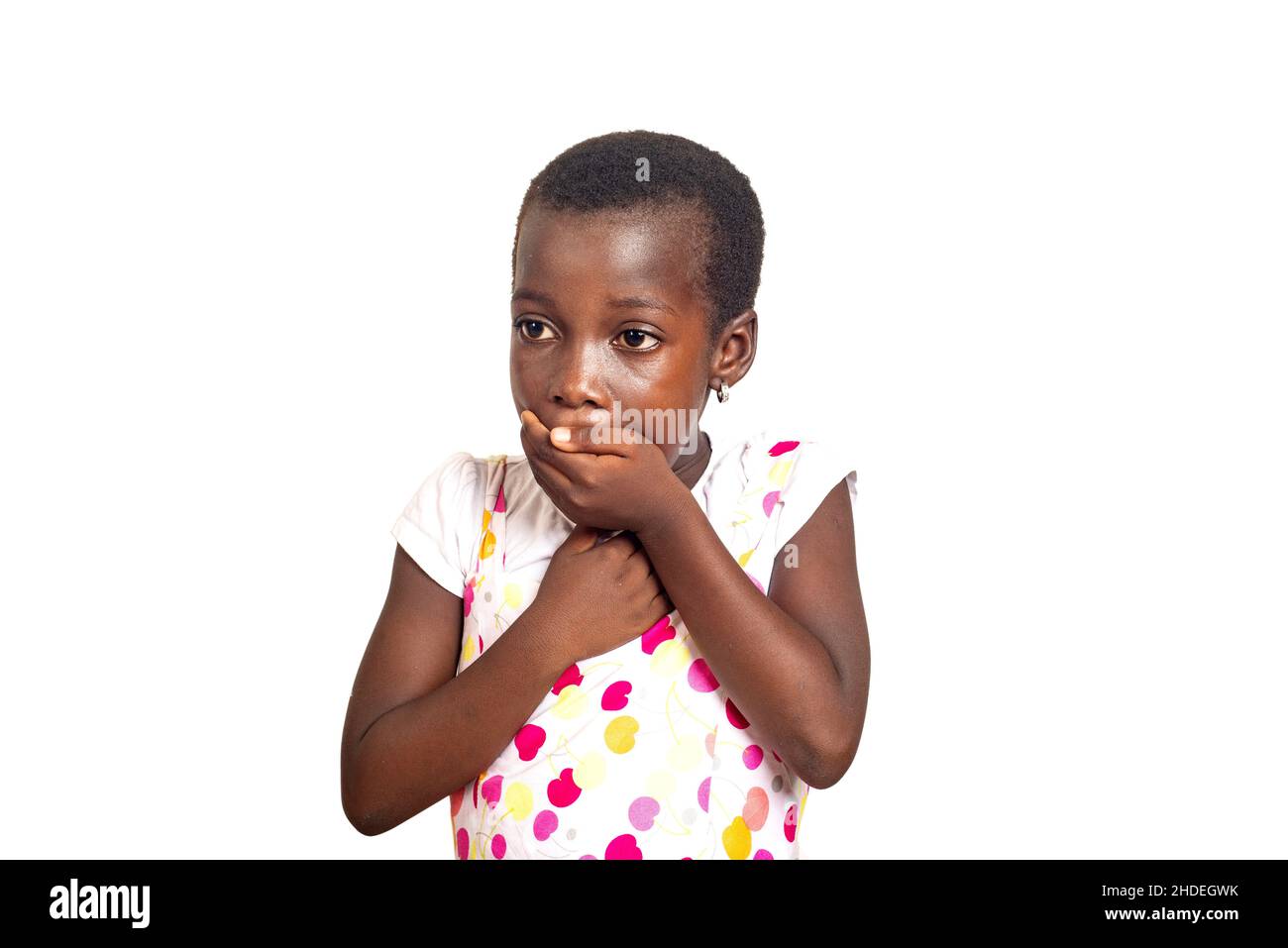 cute little child girl surprised and covering her mouth with her hands ...