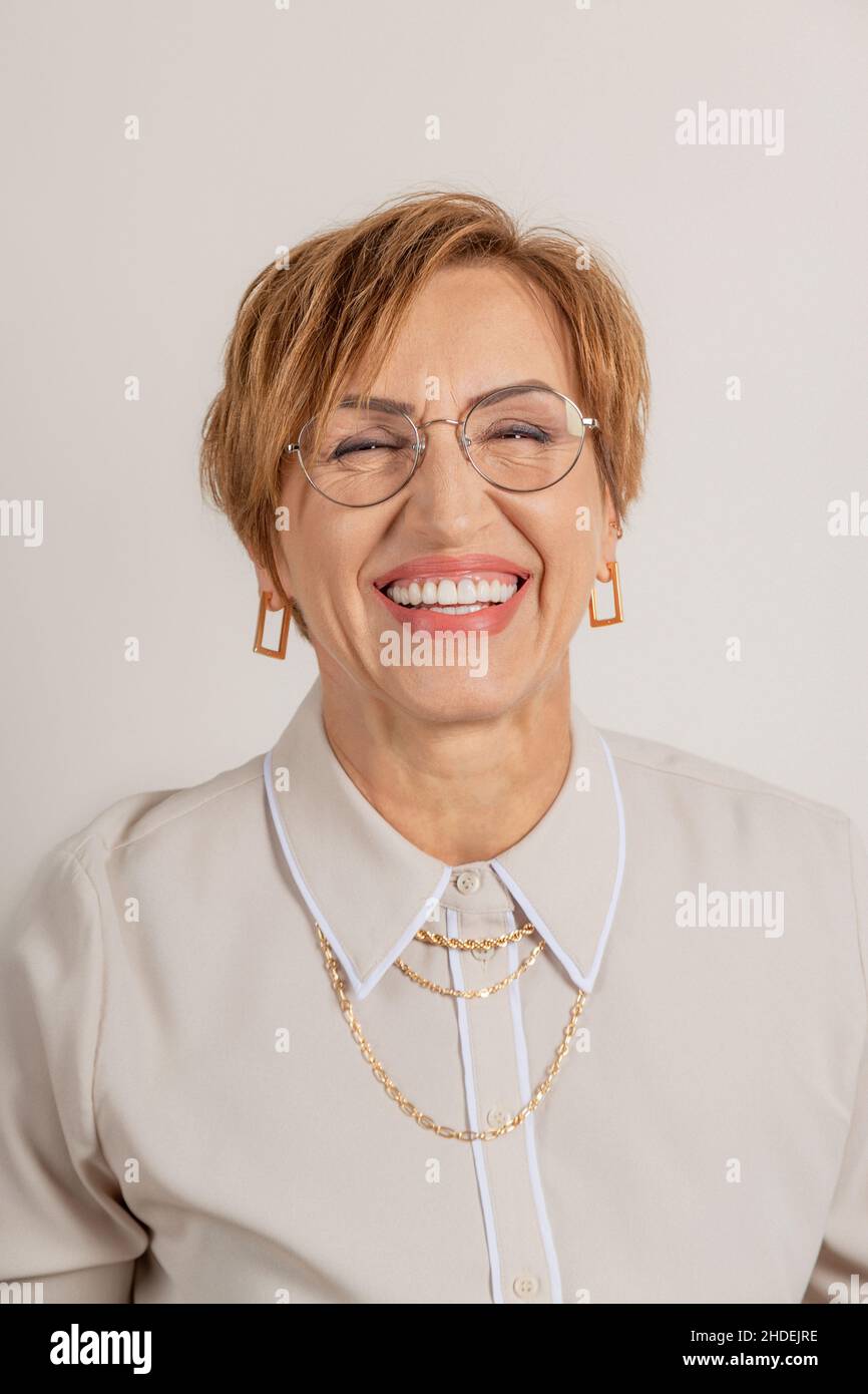 Middle-aged baby boomer woman smiles broadly with beautiful healthy teeth. Stock Photo