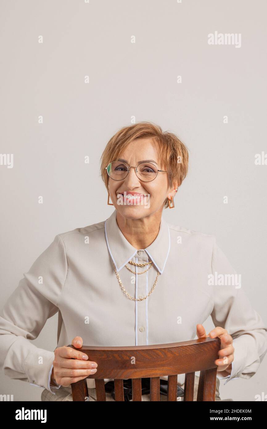 Beautiful middle-aged baby boomer woman in glasses happy smiling. Stock Photo
