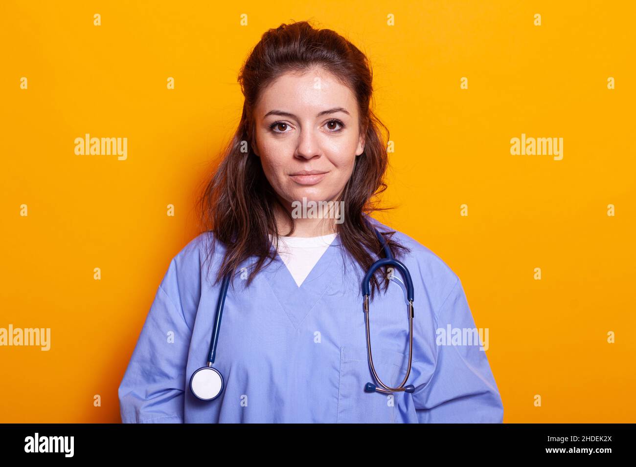Portrait of medical assistant with uniform and stethoscope looking at