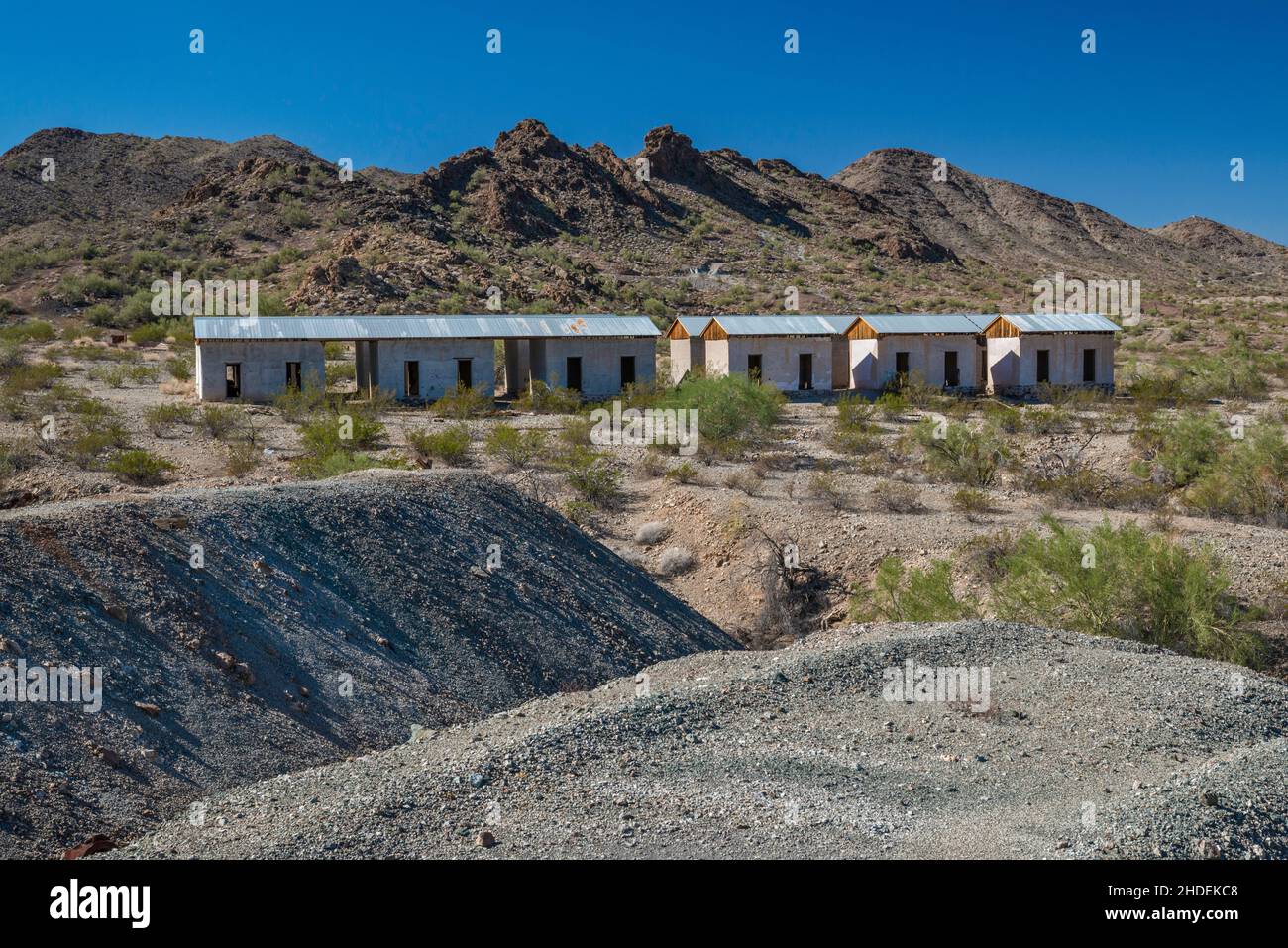Workers cottages, 1917, partially restored, waste rock tailings at Swansea copper mining townsite, Buckskin Mountains, Sonoran Desert, Arizona, USA Stock Photo