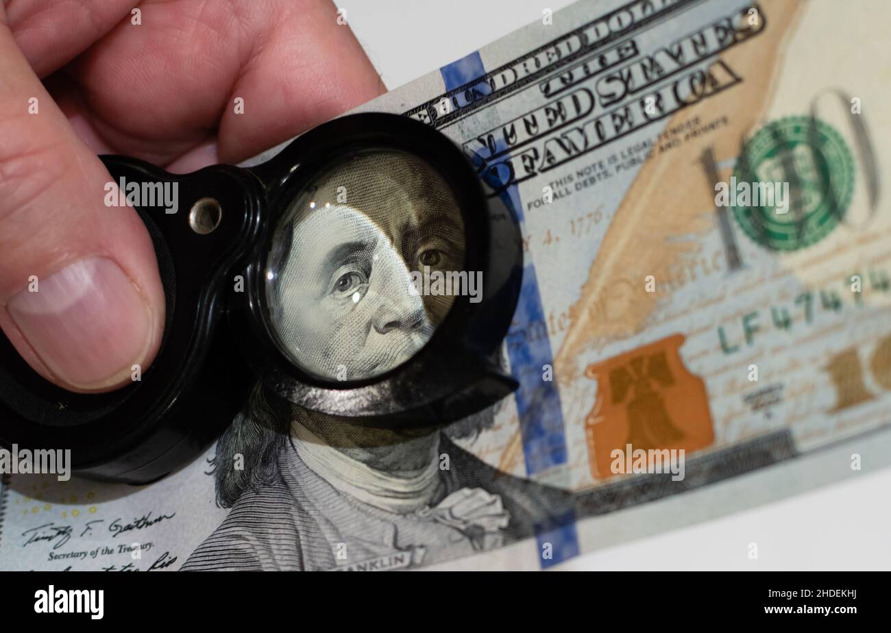 Close-up portrait of US president on dollar banknote through magnifying glass on blurred background Stock Photo