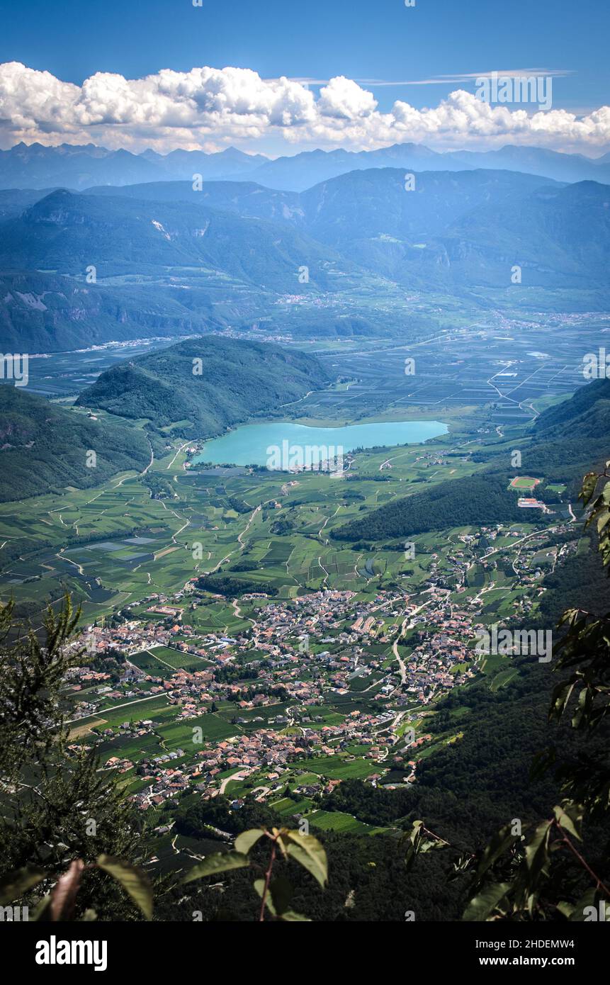 Aerial shot of a beautiful lake and town at a valley surrounded by the ...