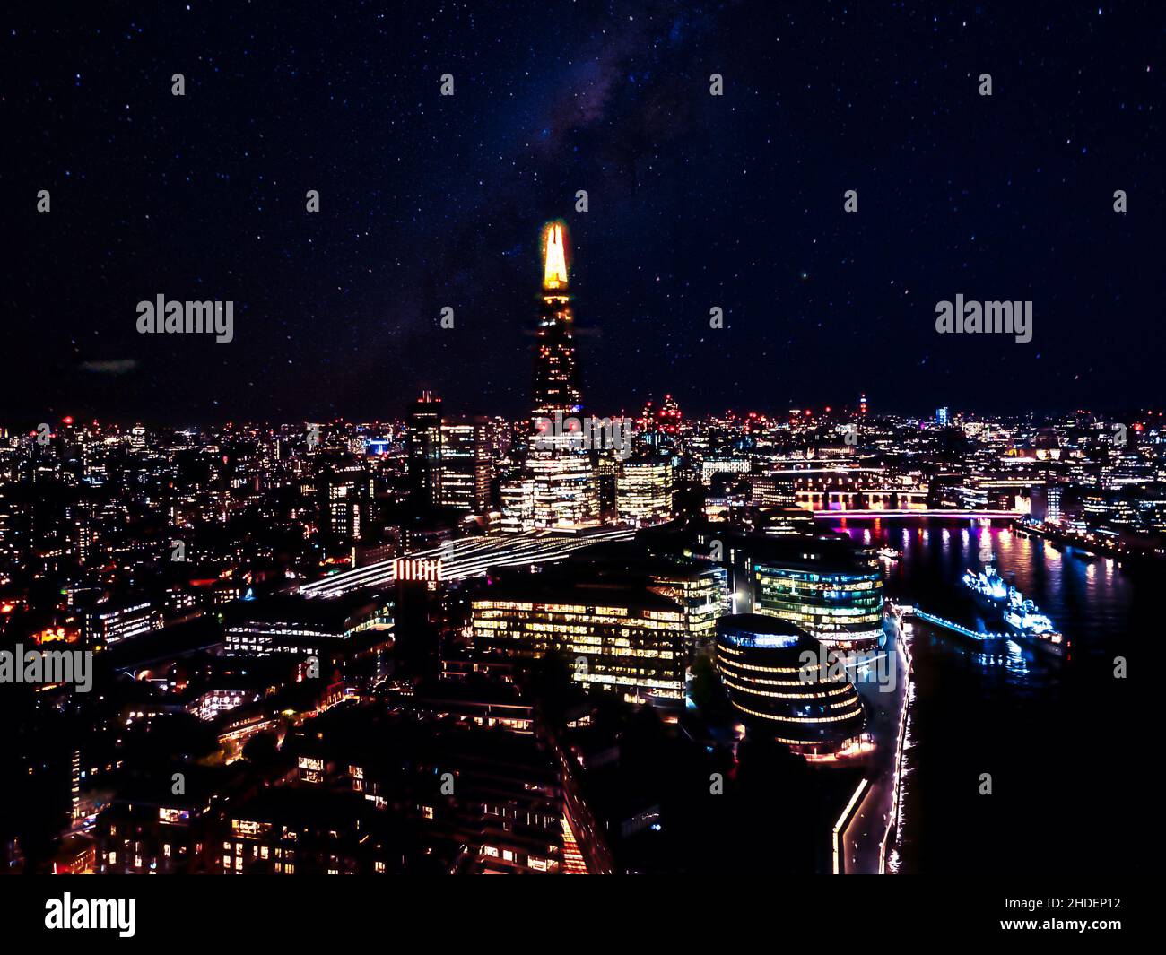 Stunning panorama view over Thames river in night the Shard, the London skyline and cityscape. Aerial photo over the big city. Stock Photo
