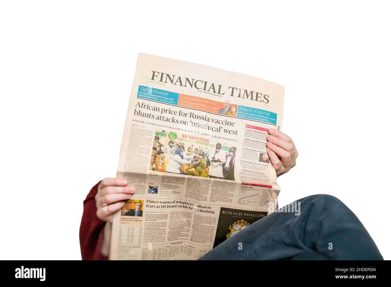 Woman reading in living room the latest Financial Times Business Stock Photo