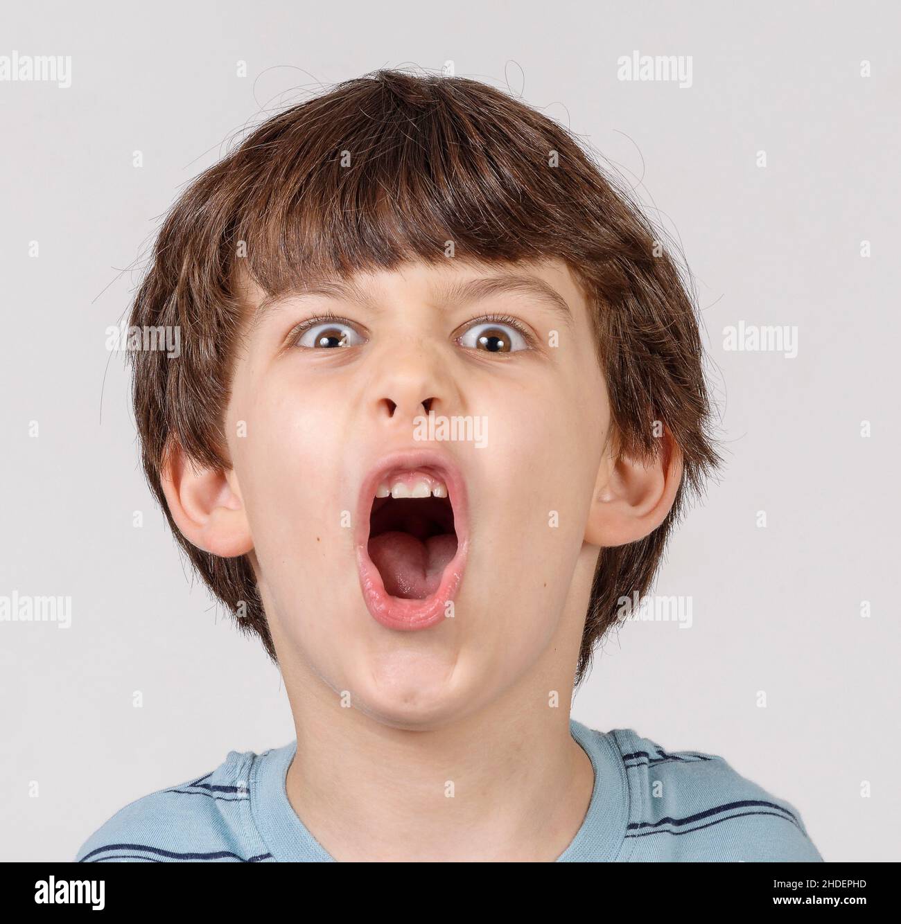 Young boy of six pulling faces Model releases Stock Photo