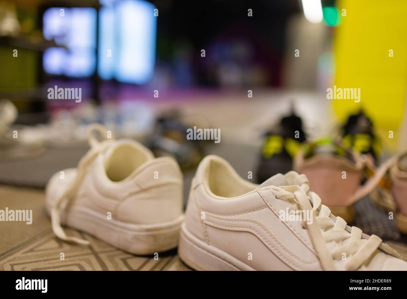 Unbranded kids shoes and wellies on shelves Stock Photo