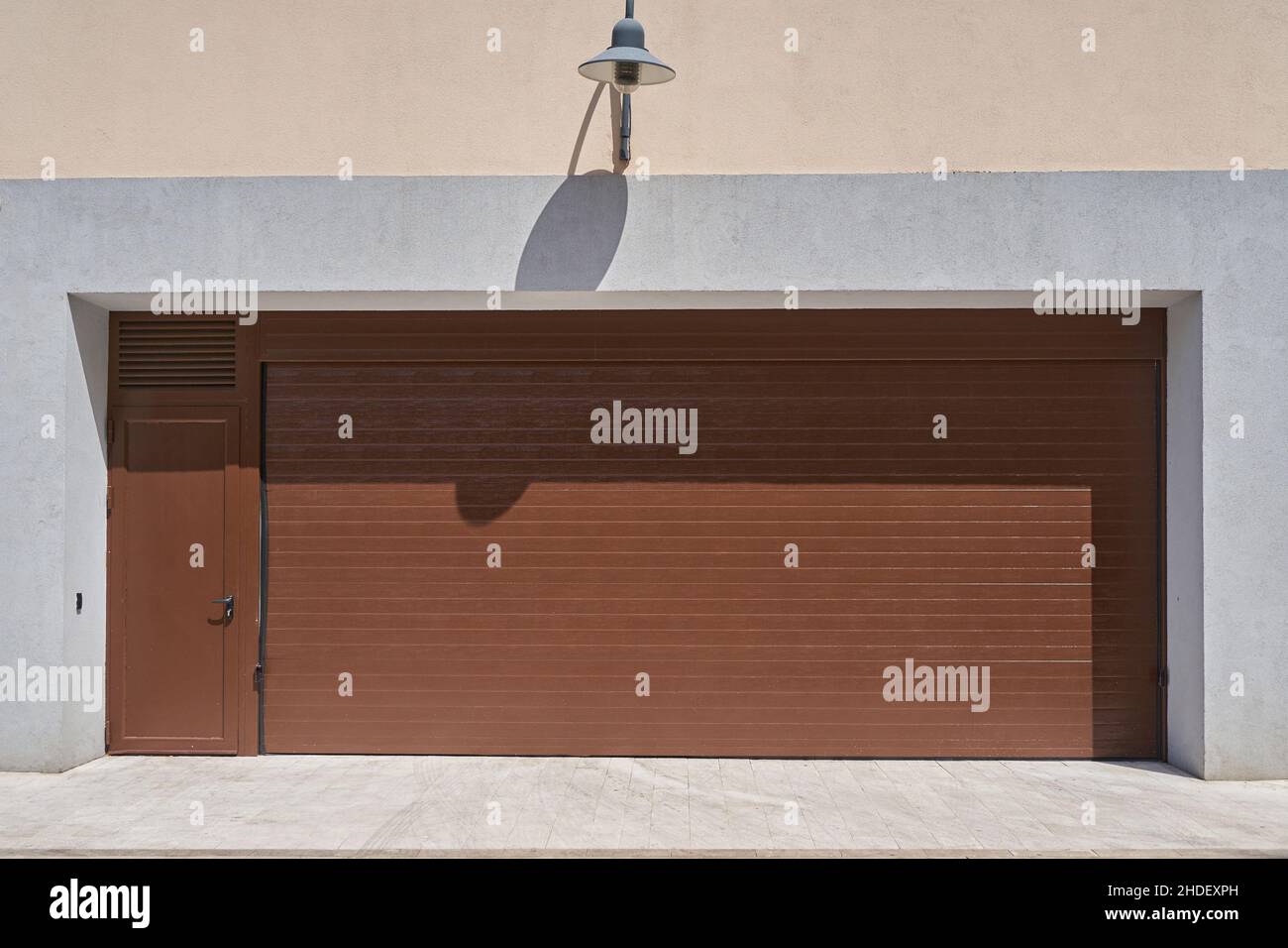 Wide rolling garage door with door Stock Photo Alamy