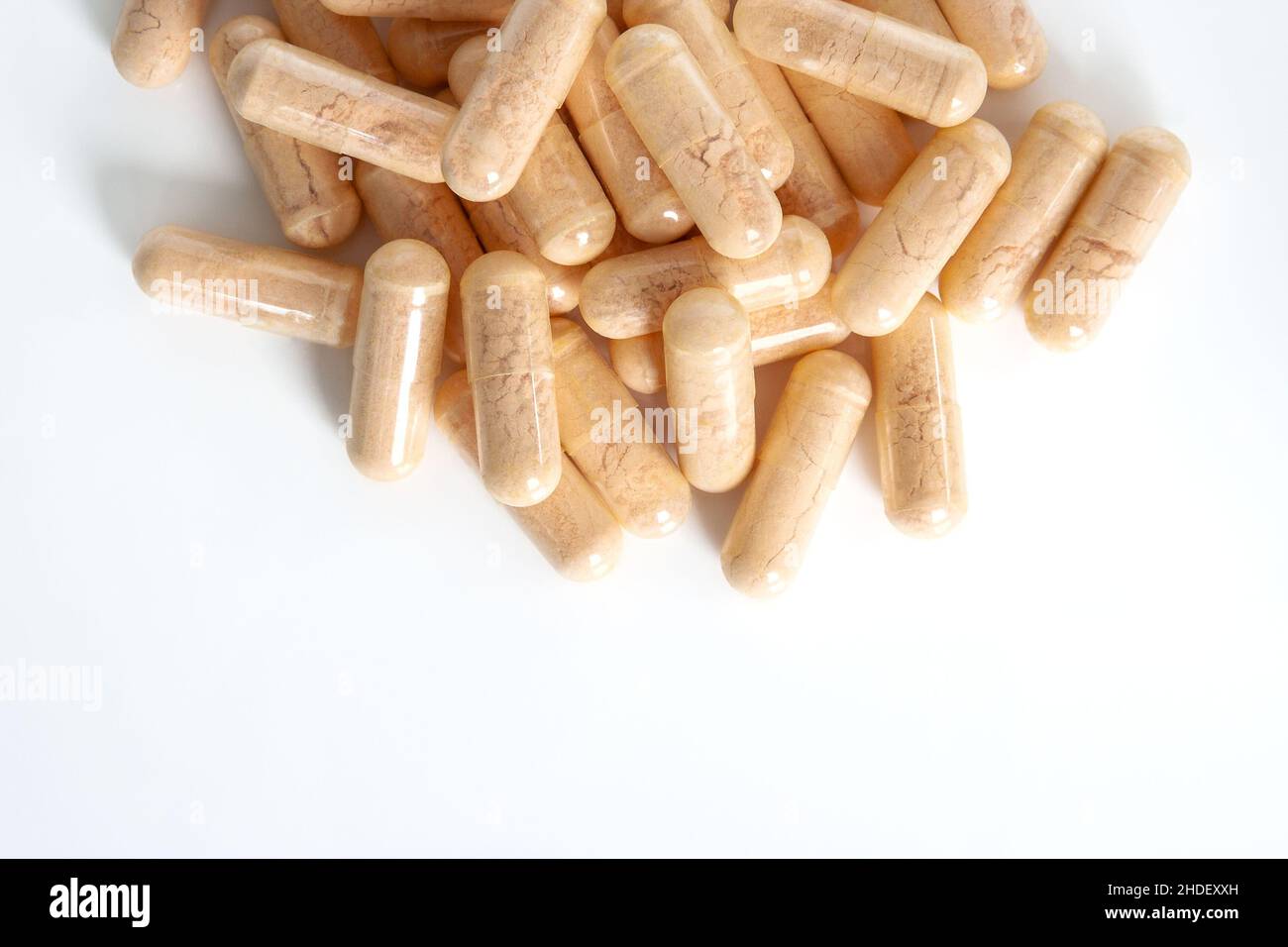 Detail of orange multivitamin supplements isolated on white background. Stock Photo