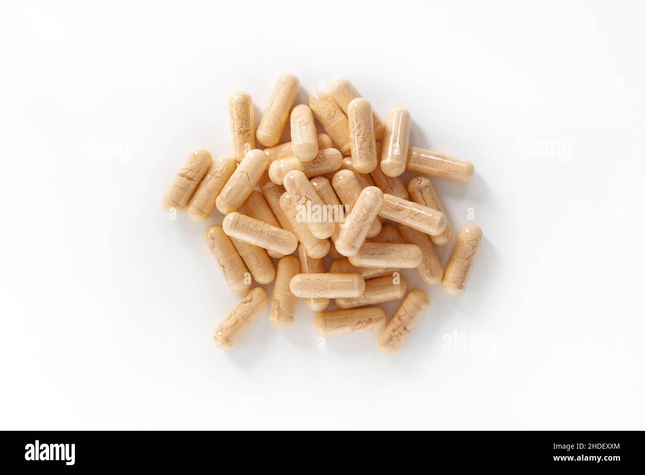 Top view of orange multivitamin supplements isolated on white background. Stock Photo