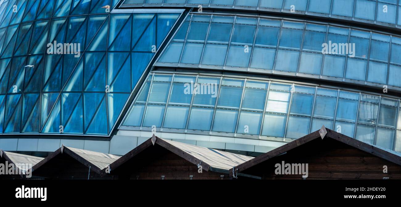 A zigzag of huts cuts through the glass and steel of County Hall, seat of local government in London, UK Stock Photo