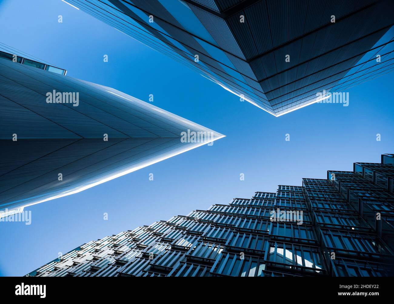 Abstract architectural images looking up at commercial buildingsmafe of glass and steel in London, UK Stock Photo