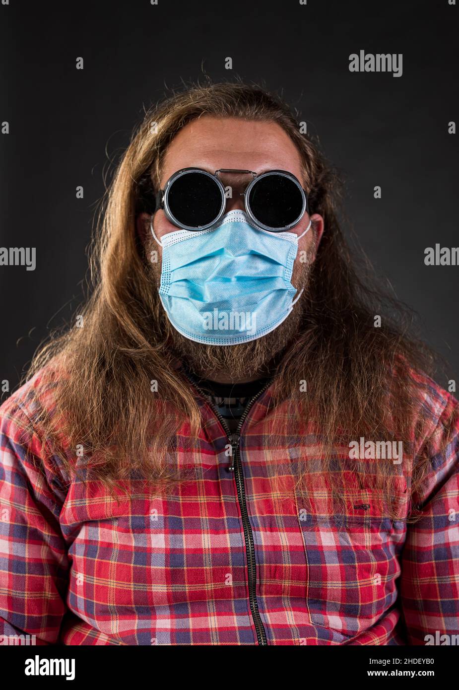 Portrait of a man with flying goggles and protective face mask Stock