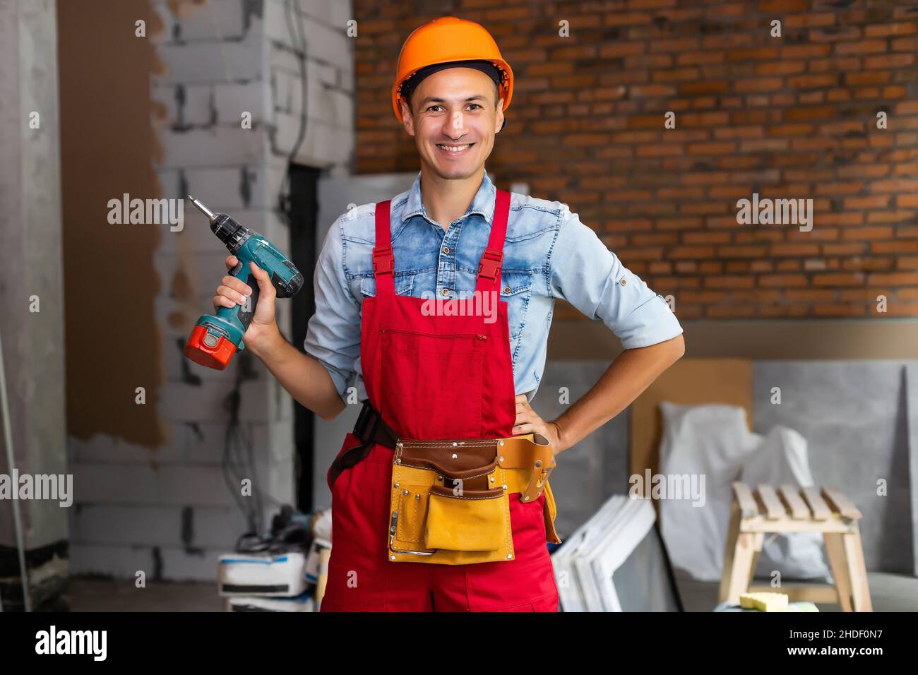 Young construction workers in hard hats in a buiding Stock Photo