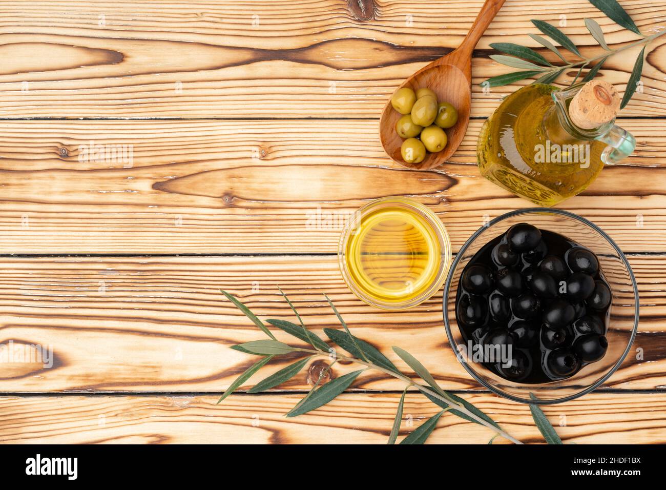 Olives and bottle of olive oil on wooden background Stock Photo Alamy